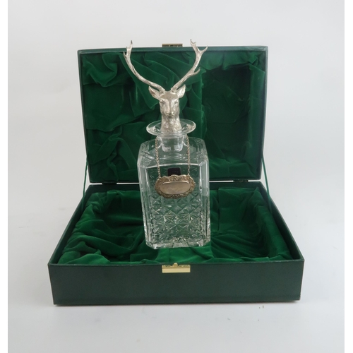 2463 - A CASED EDINBURGH CRYSTAL DECANTERof canted square form, the stopper modelled as a stag, with a silv... 
