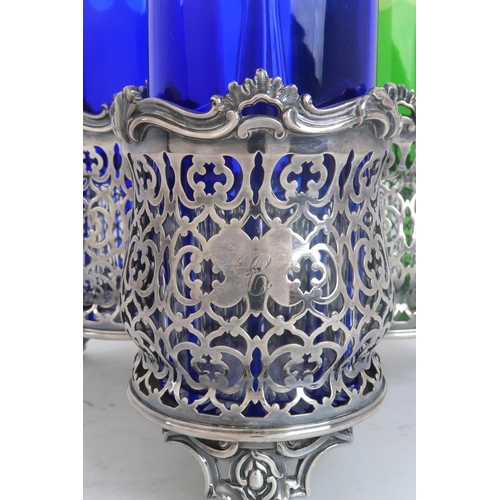 2475 - A THREE SECTION SILVER PLATED BOTTLE HOLDERof tapering cylindrical form, with pierced geometric loze... 