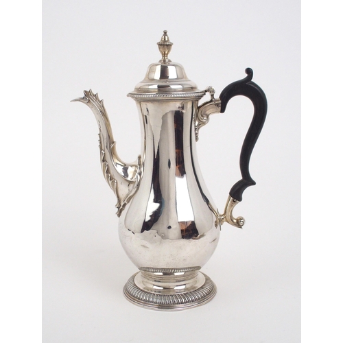2486 - A GEORGE III SILVER COFFEE POTof baluster form, with a beaded knop finial and a domed lid and gadroo... 