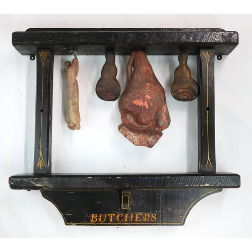 2559 - AN EARLY 20TH CENTURY BUTCHER'S SHOP CARVED WOOD WINDOW DISPLAYLargely black-painted, with hanging c... 