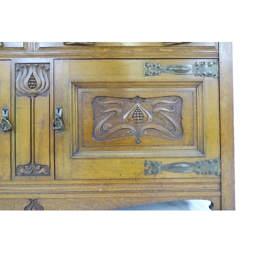 2014 - A LATE VICTORIAN OAK ARTS & CRAFTS BOOKCASEwith moulded cornice over three glazed doors over two... 