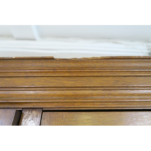 2014 - A LATE VICTORIAN OAK ARTS & CRAFTS BOOKCASEwith moulded cornice over three glazed doors over two... 