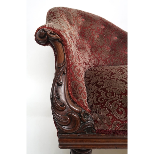 2032 - A VICTORIAN MAHOGANY FRAMED CHAISE LONGUEwith foliate carvings, buttonback and seat upholstered in a... 
