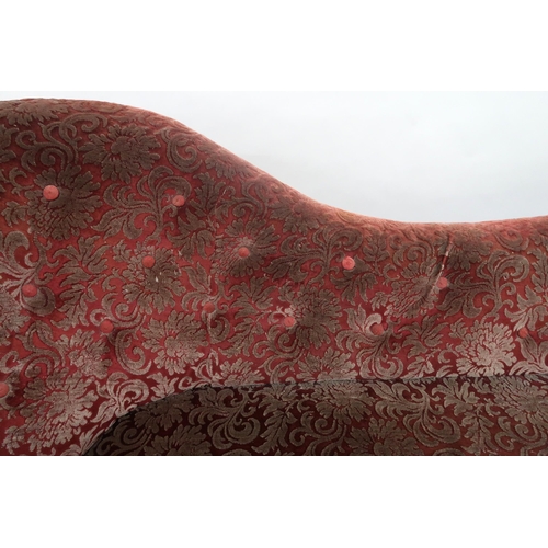 2032 - A VICTORIAN MAHOGANY FRAMED CHAISE LONGUEwith foliate carvings, buttonback and seat upholstered in a... 