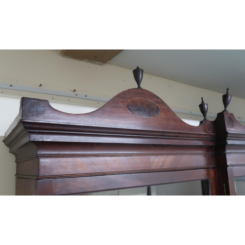 2034 - A 19TH CENTURY MAHOGANY BREAKFRONT LIBRARY BOOKCASEwith moulded serpentine cornice topped with turne... 