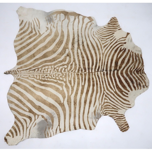 2038 - A 20TH CENTURY BROWN AND WHITE PRINTED COWHIDE RUGrug is 182cm long x 182cm wide... 