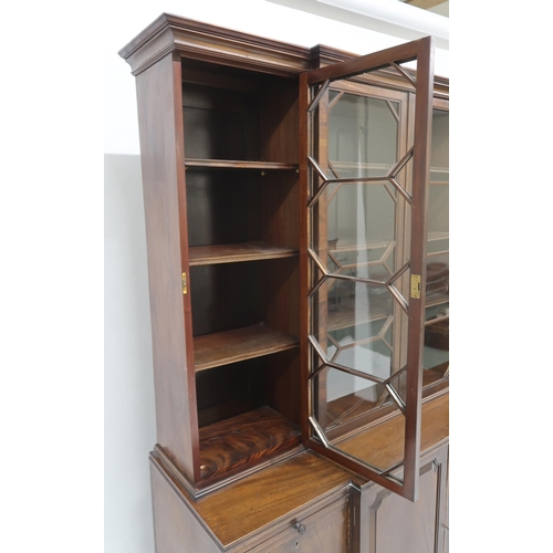 2039 - A 19TH CENTURY MAHOGANY BREAKFRONT BOOKCASEwith moulded cornice over four beaded glazed doors over p... 