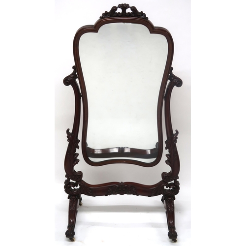 2042 - A VICTORIAN MAHOGANY FRAMED CHEVAL DRESSING MIRRORwith shaped mirror on scrolled foliate carved upri... 