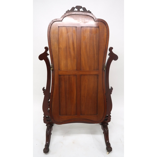 2042 - A VICTORIAN MAHOGANY FRAMED CHEVAL DRESSING MIRRORwith shaped mirror on scrolled foliate carved upri... 