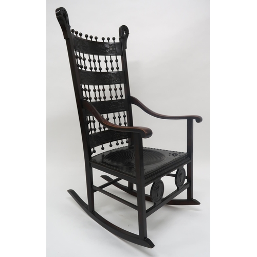 2044 - A 19TH CENTURY CONTINENTAL ROCKING CHAIRwith carved slated back interspaced with turned bobbins over... 
