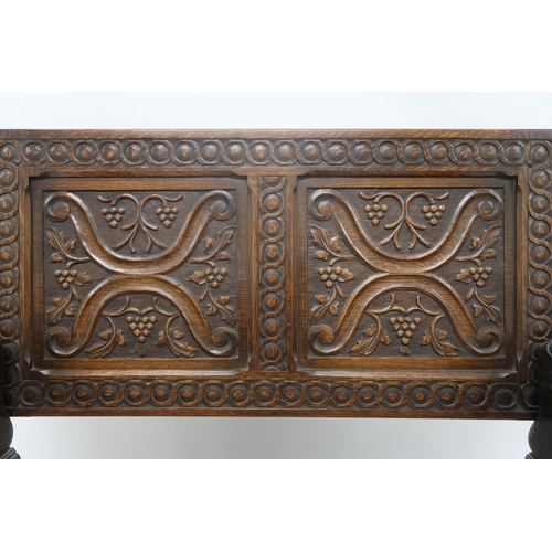 2045 - AN EARLY 20TH CENTURY CARVED OAK MONKS BENCHcarved hinged top over carved lion arms flanking central... 