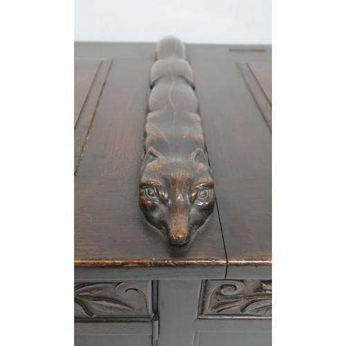 2049 - AN ARTS AND CRAFTS OAK AND BURR WALNUT COFFERthe three section hinged top carved with foxes and rais... 