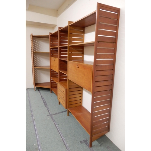 2108 - A MID 20TH CENTURY TEAK STAPLES LADDERAX MODULAR SHELVING SYSTEMcomprising five panel uprights, stee... 