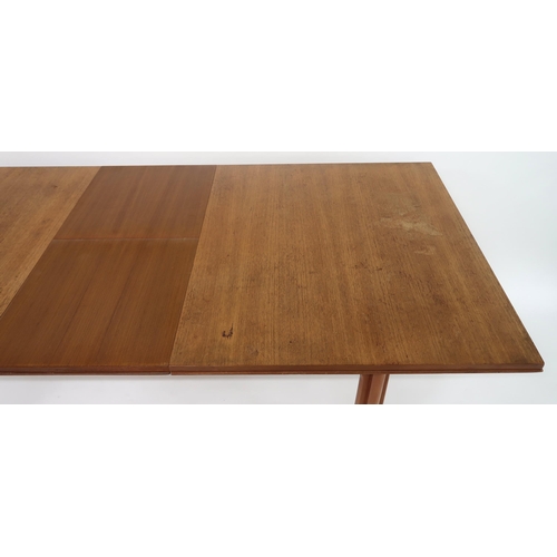 2112 - A MID 20TH CENTURY TEAK EXTENDING DINING TABLEwith rectangular top concealing three internal leaves ... 