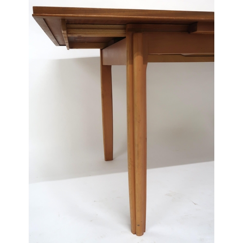 2112 - A MID 20TH CENTURY TEAK EXTENDING DINING TABLEwith rectangular top concealing three internal leaves ... 