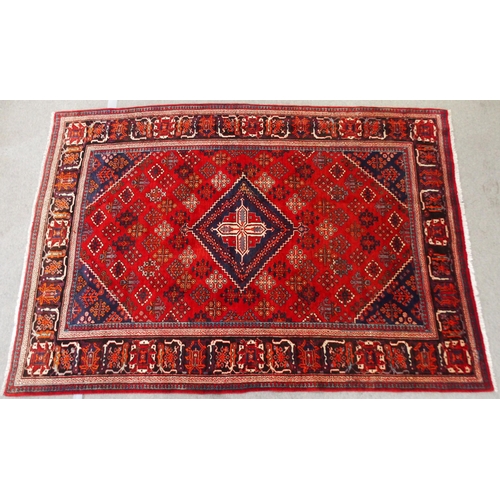 2133 - A RED GROUND MEIMEH RUGwith dark blue central medallion, matching spandrels and dark blue flower hea... 
