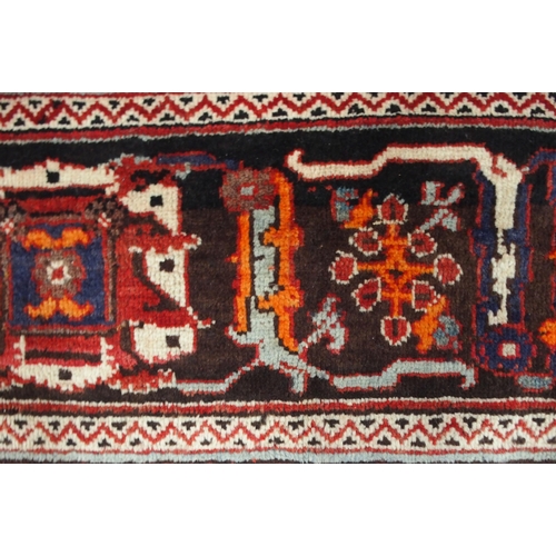 2133 - A RED GROUND MEIMEH RUGwith dark blue central medallion, matching spandrels and dark blue flower hea... 