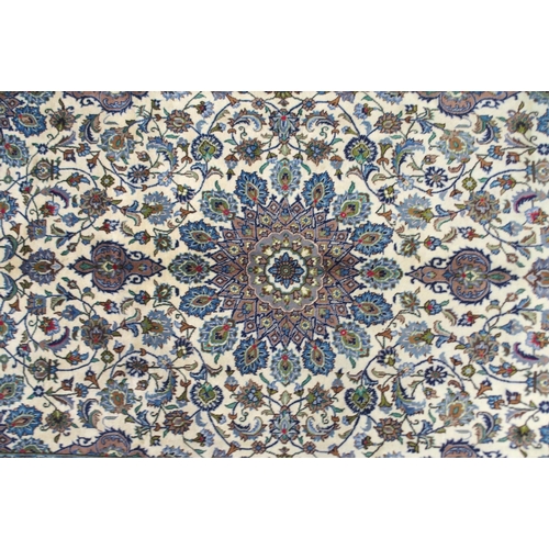2137 - A CREAM GROUND MESHED RUGwith multicolour flower head central medallion, matching spandrels and flow... 