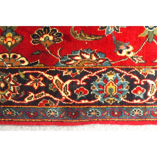2139 - A RED GROUND TABRIZ RUGwith all-over floral design and dark blue flower head border, 166cm long x 99... 