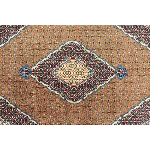 2141 - A COPPER GROUND TABRIZ GROUND RUGwith multicoloured central medallion, matching spandrels and multic... 