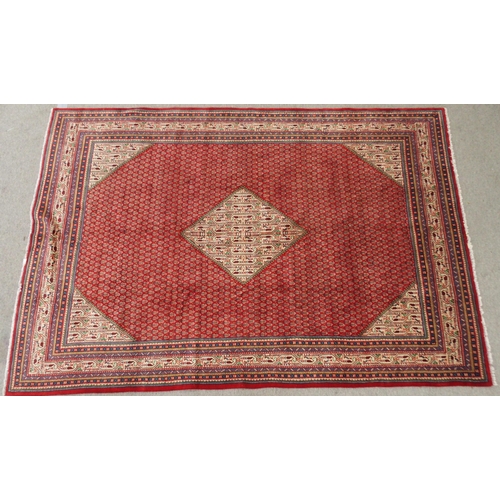 2143 - A RED GROUND ARAAK BOTTEH PATTERN RUGwith cream central diamond medallion, matching spandrels and mu... 