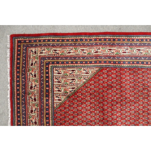 2143 - A RED GROUND ARAAK BOTTEH PATTERN RUGwith cream central diamond medallion, matching spandrels and mu... 