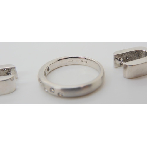 2702 - AN 18CT WHITE GOLD DIAMOND DOT RINGthe brushed textured surface set with seven brilliant cut diamond... 