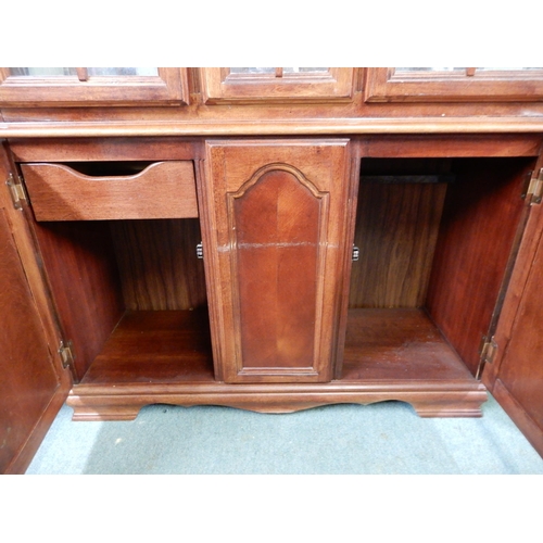 146 - A 20th century mahogany glazed display cabinet with moulded cornice over pair of glazed doors over p... 