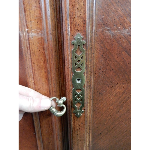 146 - A 20th century mahogany glazed display cabinet with moulded cornice over pair of glazed doors over p... 