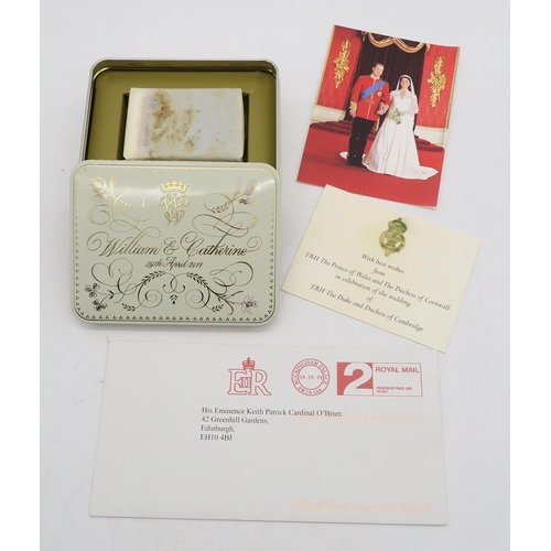 648 - A slice of cake from the wedding of TRH the Duke and Duchess of Cambridge, contained in a tin, the l... 