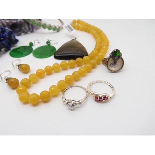 929 - A honey jade necklace and earrings, a Russian diopside silver snake ring, a lapis lazuli, necklace a... 