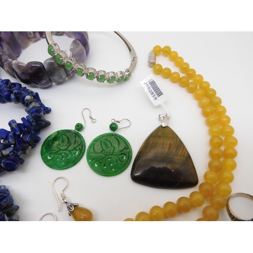 929 - A honey jade necklace and earrings, a Russian diopside silver snake ring, a lapis lazuli, necklace a... 