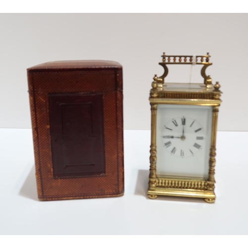 298 - A French brass and glass carriage clock with column supports and galleried detail, with travel case ... 