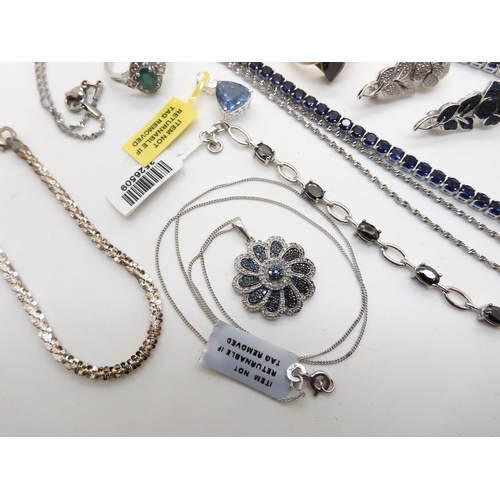 970 - A wide silver bracelet, a silver blue and white diamond set flower pendant, with a further two rose ... 