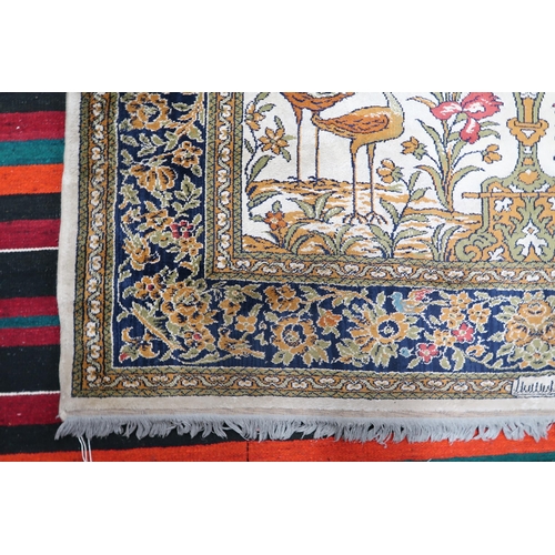 112 - A pair 20th century wool tree of life pattern rugs with floral foliate border, 228cm long x 171cm wi... 