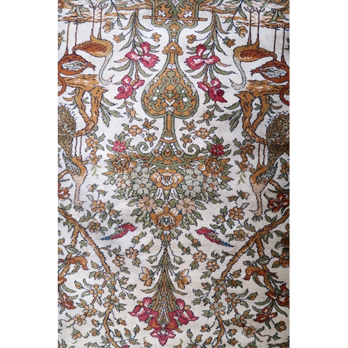 112 - A pair 20th century wool tree of life pattern rugs with floral foliate border, 228cm long x 171cm wi... 