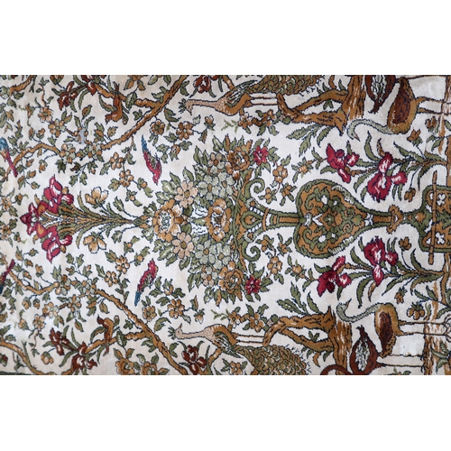 113 - A pair 20th century wool tree of life pattern rugs with floral foliate border, 228cm long x 171cm wi... 