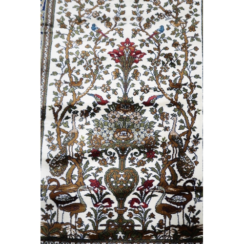 114 - A pair 20th century wool tree of life pattern rugs with floral foliate border, 180cm long x 133cm wi... 