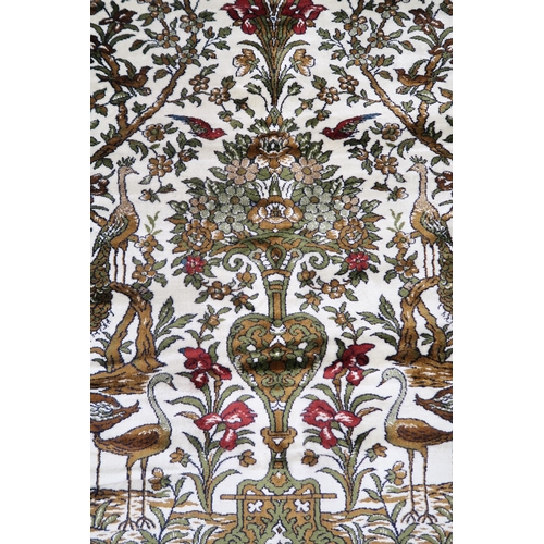 115 - A 20th century wool tree of life pattern rugs with floral foliate border, 227cm long x 170cm wide an... 