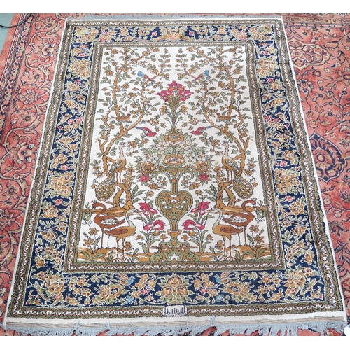 115 - A 20th century wool tree of life pattern rugs with floral foliate border, 227cm long x 170cm wide an... 