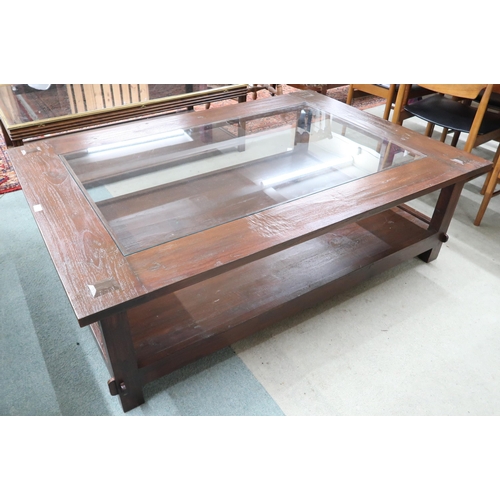 120 - A 20th century Indonesian hardwood Lombok coffee table with glazed inset top, 49cm high x 161cm long... 