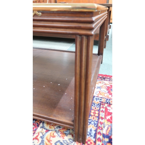 121 - A 20th century mahogany and brass framed two tier coffee with smoke glass top, 46cm high x 140cm lon... 