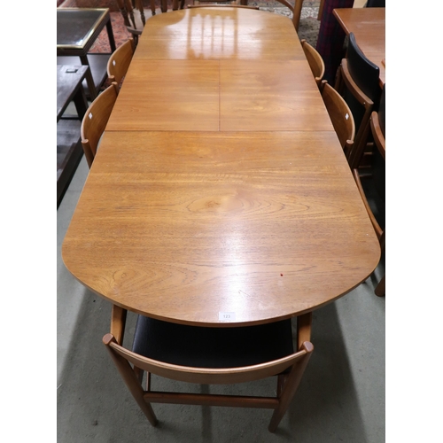 123 - A mid 20th century teak extending dining table and six chairs, dining table with one internal leaf o... 