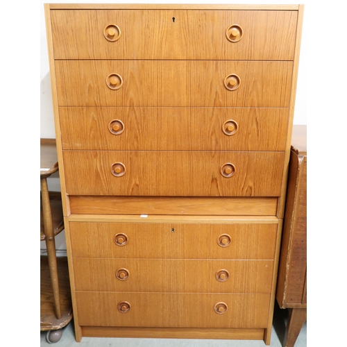 124 - A lot of two mid 20th century teak veneered chests of drawers with shaped inset handles, four drawer... 