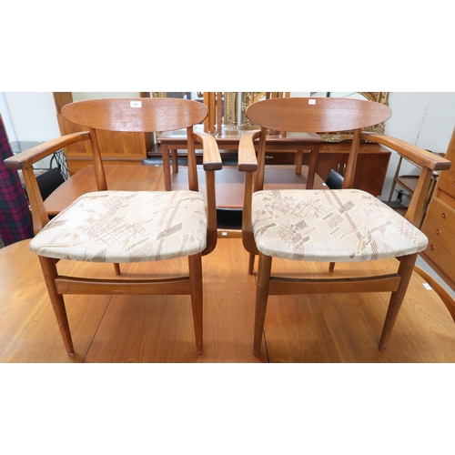 126 - A pair of mid 20th century teak framed dining carvers with velour upholstered seats (2)