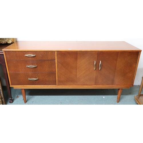 129 - A mid 20th century teak sideboard with pair of cabinet doors alongside three drawers on tapering sup... 