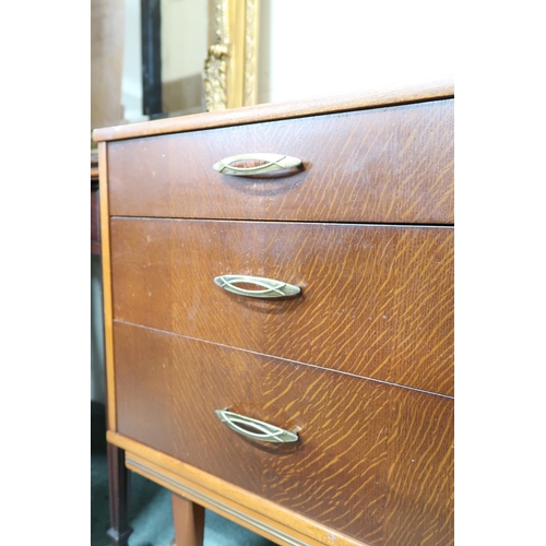 129 - A mid 20th century teak sideboard with pair of cabinet doors alongside three drawers on tapering sup... 