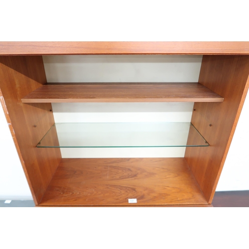 131 - A mid 20th century teak drinks cabinet with two open shelves over fall front compartment over single... 