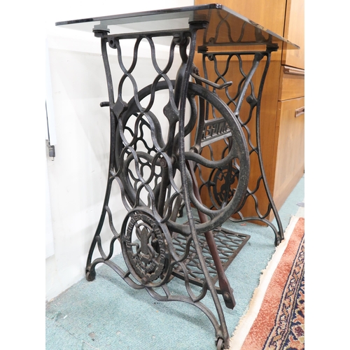 132 - A 20th century Singer treadle sewing machine base converted to a glass to lamp table, 72cm high x 70... 