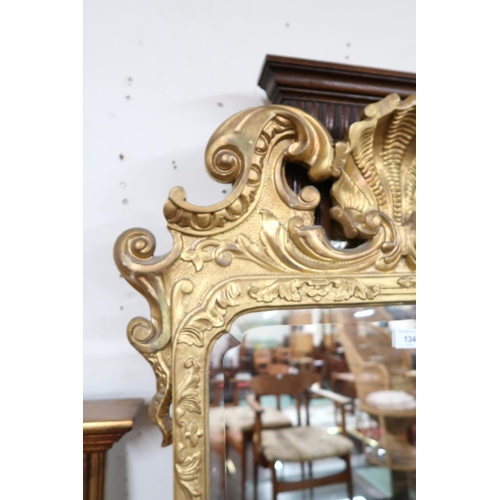 134 - A 20th century gilt framed Rococo style wall mirror, 112cm high x 67cm wide and a gilt framed overma... 